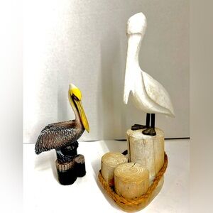 Lot of 2 Vintage pelican statues sitting on wood